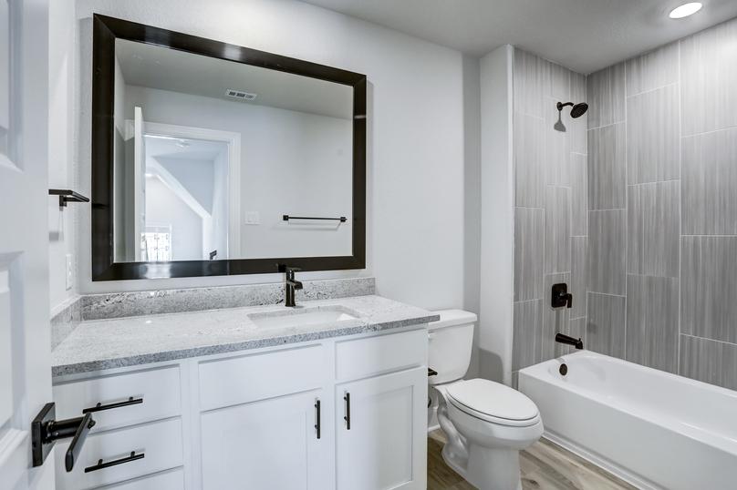 Guest bathroom with extra storage space and a dual shower and tub.