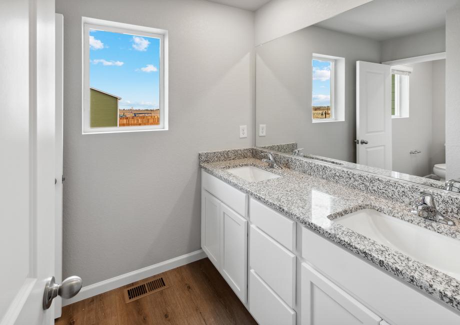 Secondary bathroom with a window and private restroom.