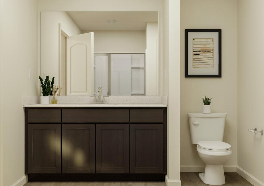 Rendering of the owner's bathroom
  featuring a wood and granite vanity and toilet.