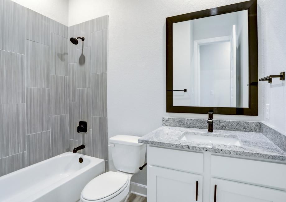 Secondary bathroom with a tile-lined dual shower and tub.