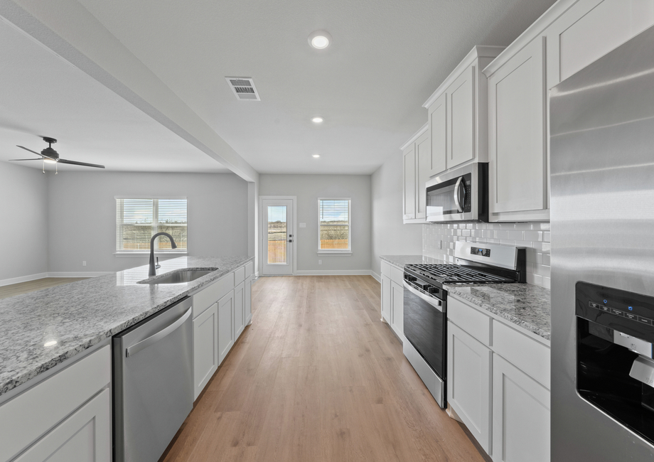 The kitchen has sprawling granite countertops.