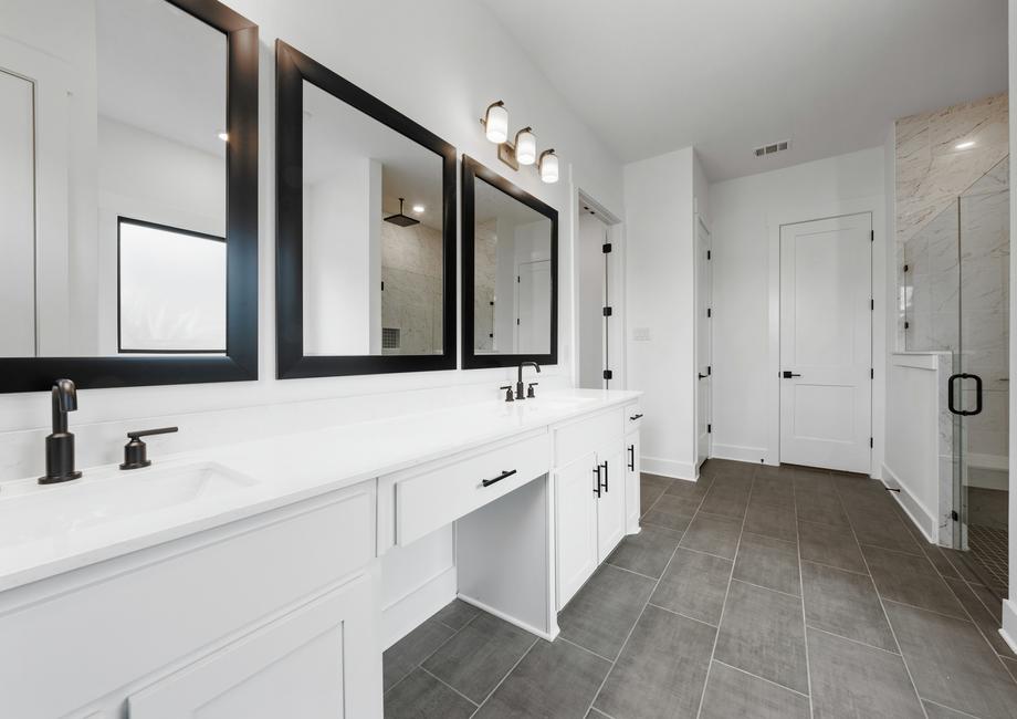 The gorgeous master bathroom has a giant vanity space that has two sinks and vanity space.