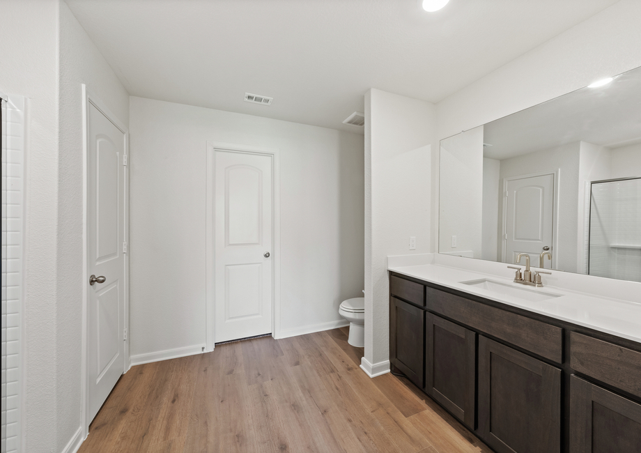 The master bathroom has a large vanity space.