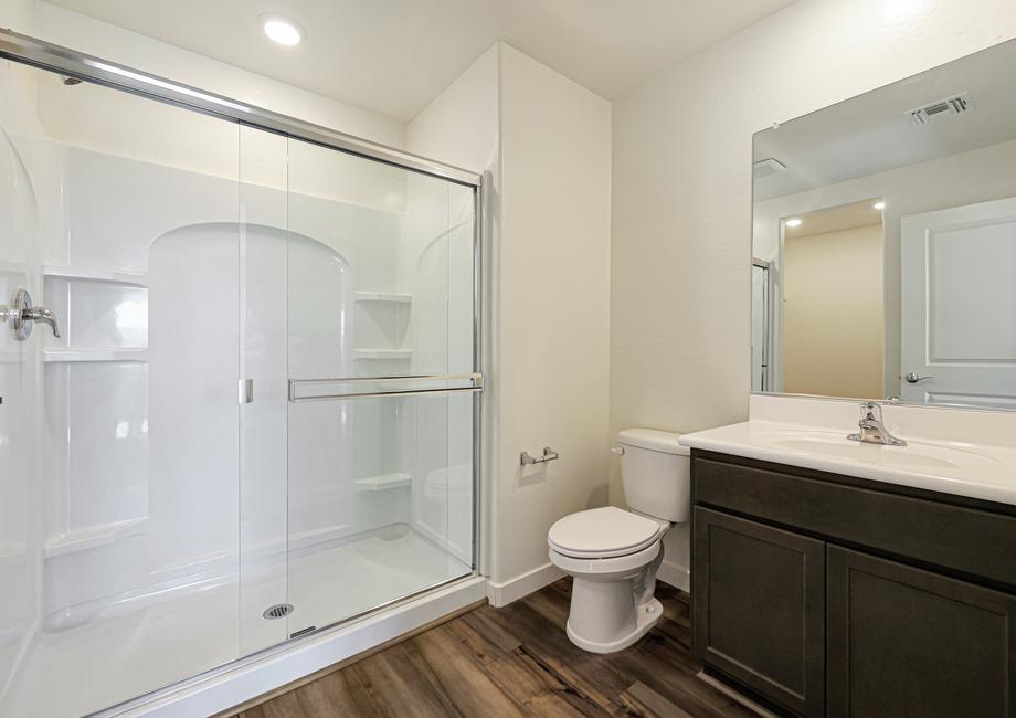 The master bath has a spacious, glass-enclosed shower.