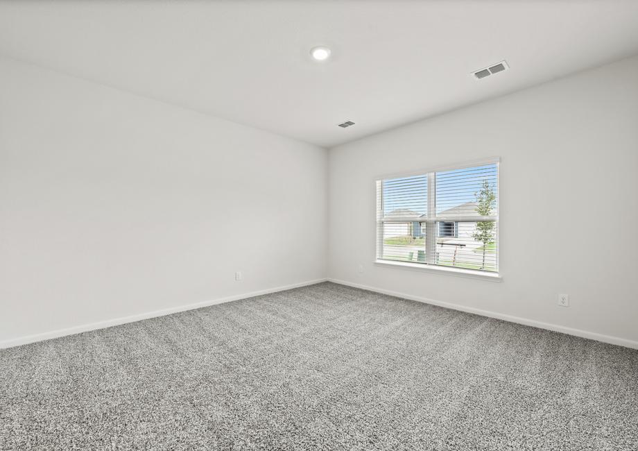 The master bedroom of the Cypress is large and has a window that lets in great, natural light.