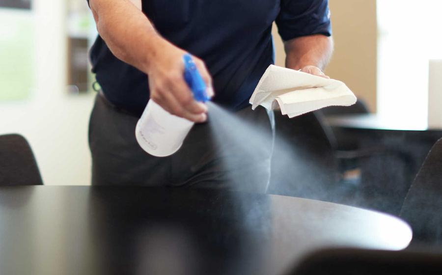Man cleaning table