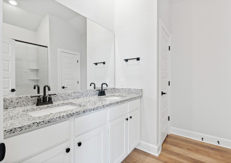 Beautiful master bathroom including dual sink vanity with marble countertops and upgraded hardware.