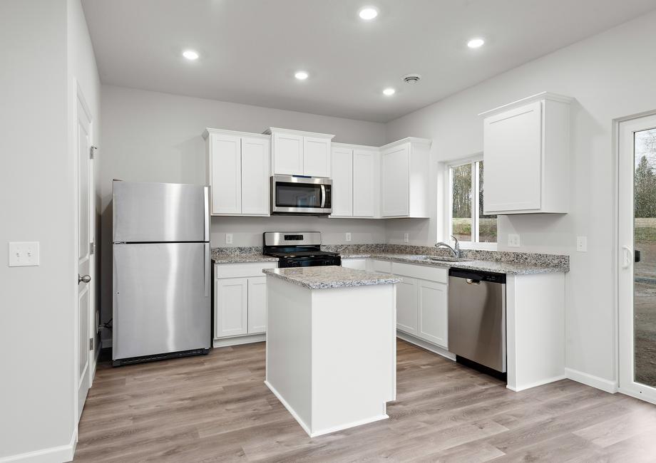 The kitchen has stainless steel appliances and plank flooring.