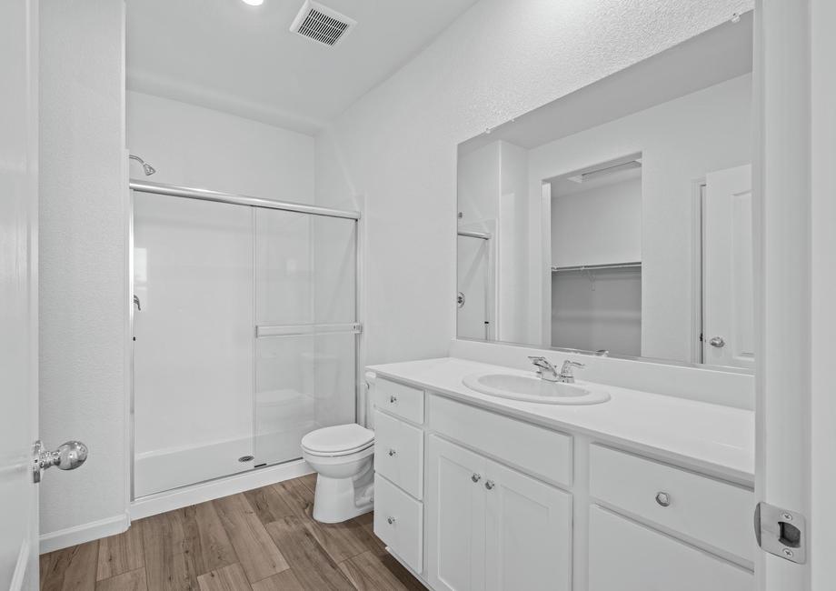 The master bathroom is spacious with a step in shower.