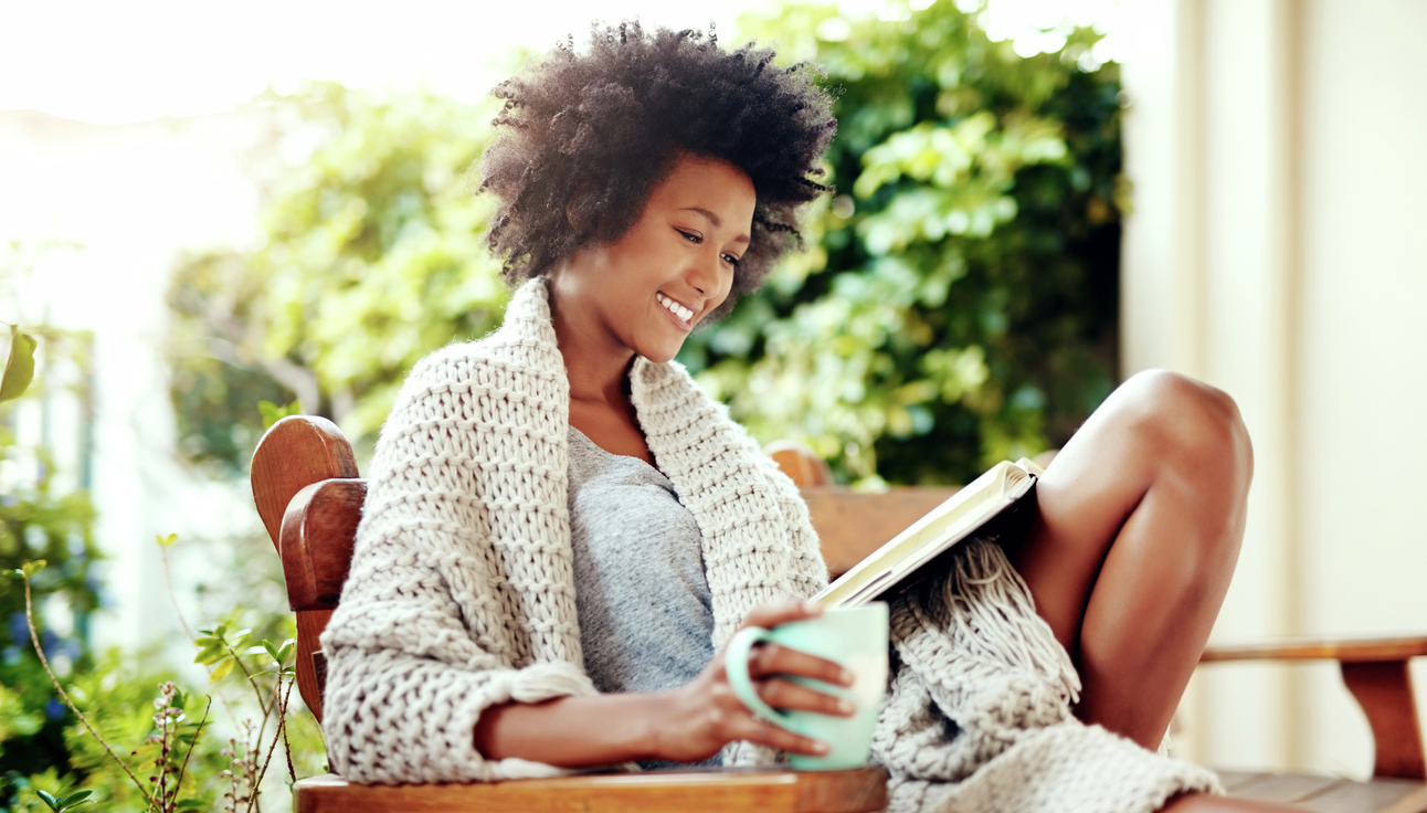 Woman drinking coffee on patio.