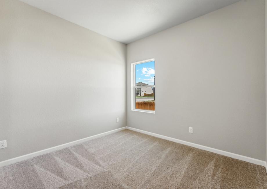 The secondary bedroom has a large window and lots of space.