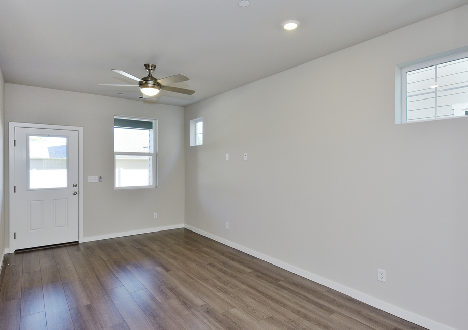 The family room is spacious with a ceiling fan.