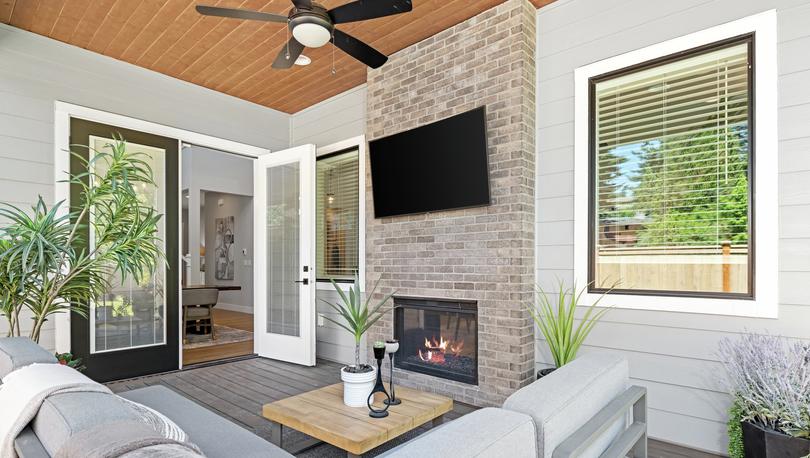 Outside is an incredible covered living area with a fireplace.