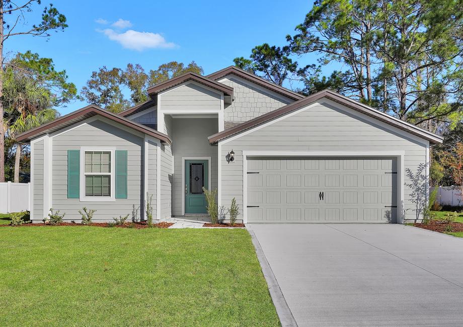 This beautiful home features a turquoise door and shutters.