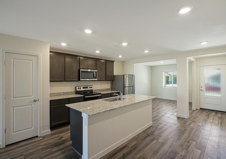 Enjoy stunning granite countertops and designer wood cabinetry in this kitchen.