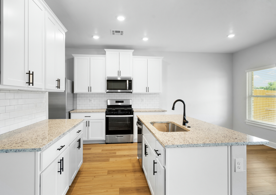 The upgraded kitchen has beautiful sprawling granite countertops.