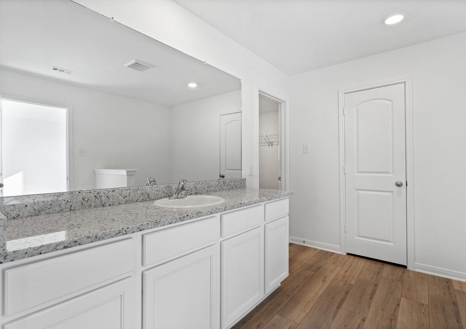 The master bathroom comes with a long vanity.