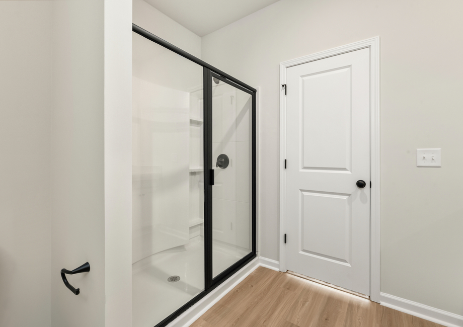 This bathroom has a glass-enclosed shower