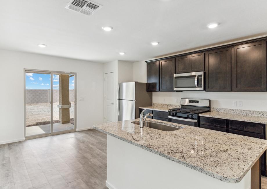 Upgraded kitchen with granite countertops and espresso cabinetry.