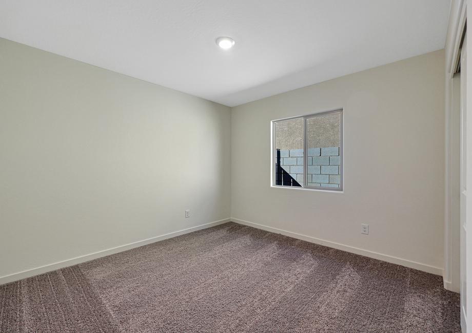 Windows let in plenty of light to this secondary bedroom.