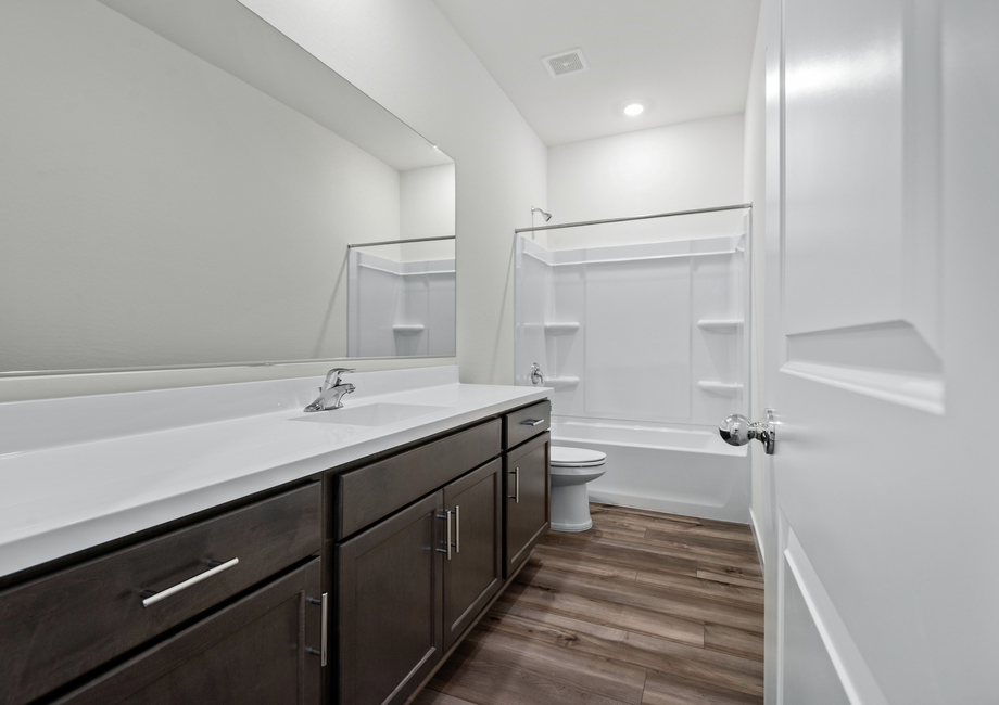 The secondary bathroom has ample space for guests to get ready.