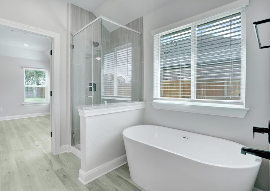 Luxurious master bath with a soaking tub and walk-in shower, making it feel like a spa.