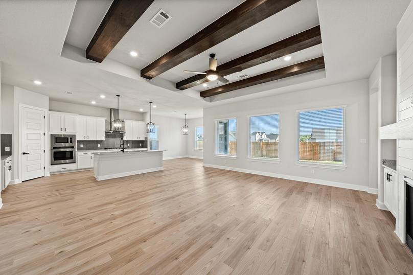Spacious open floor plan with beams on the ceiling.