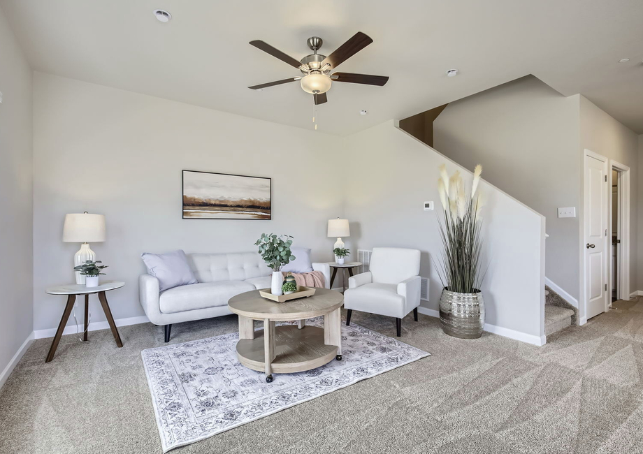 The family room is spacious with a ceiling fan.