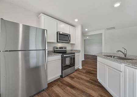 The kitchen is chef-ready with stainless steel appliances