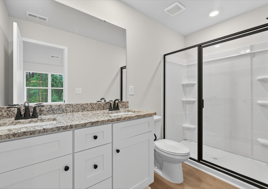 The master has a glass-enclosed shower. 