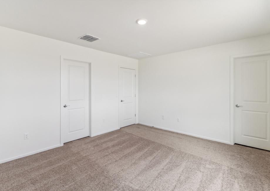 The master bedroom with an attached bathroom and walk-in closet.