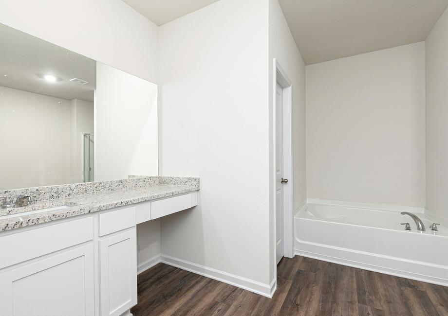 The master bathroom includes a separate walk-in shower and bathtub