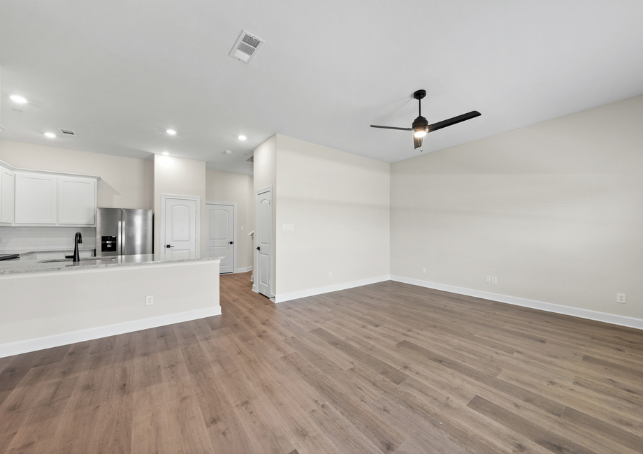 The open living areas connect the family room, dining area and kitchen.