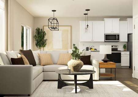 Rendering of living room with a large
  sectional couch and a coffee table. The kitchen can be seen from behind the
  couch.