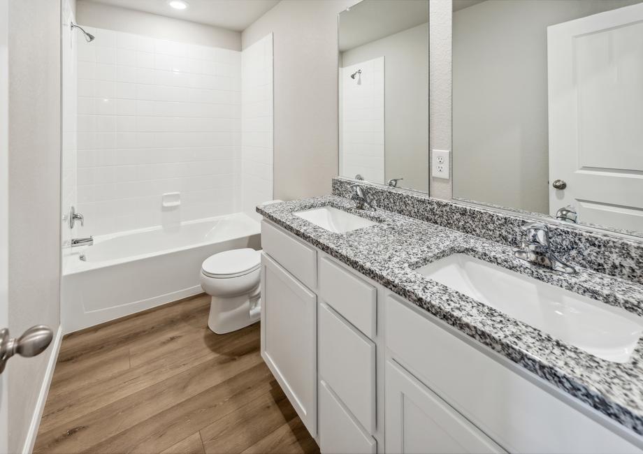 Secondary bathroom with a dual shower and tub.