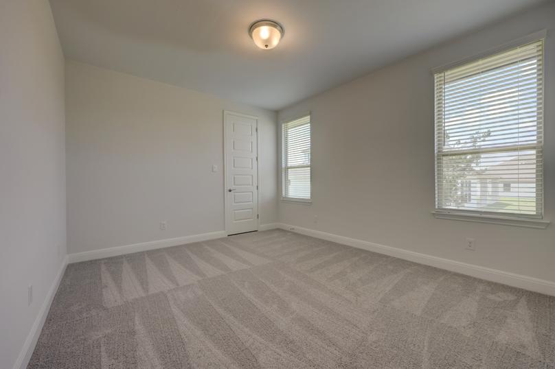 Secondary bedroom with two windows to allow natural light to flow through.