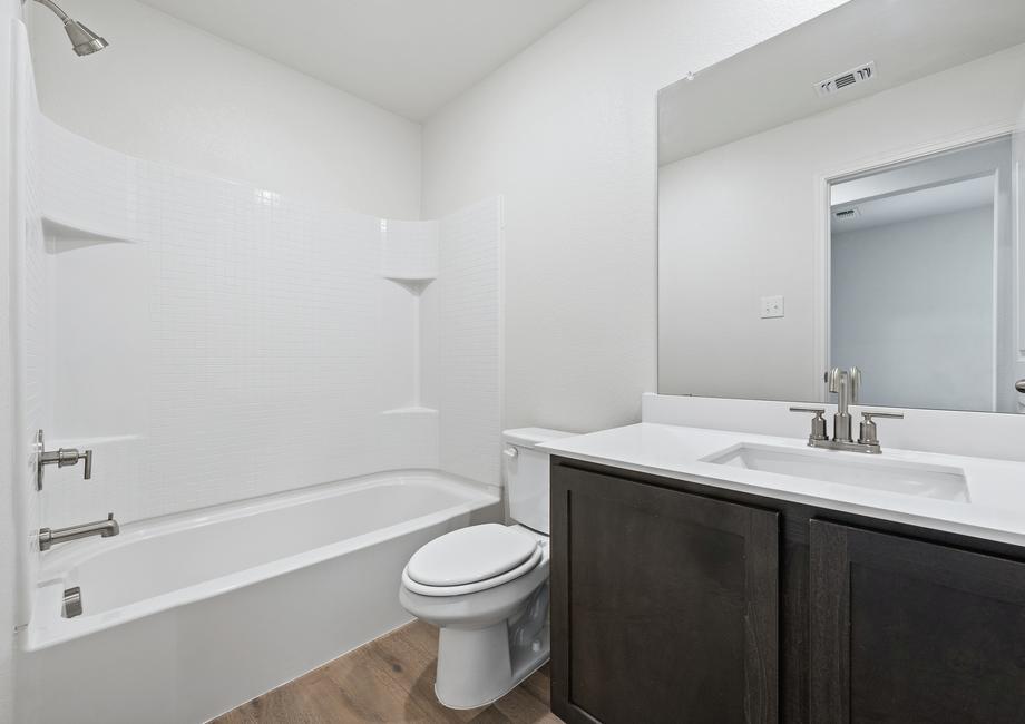 The secondary bathroom of the Sabine has a large vanity and shower-tub combo.