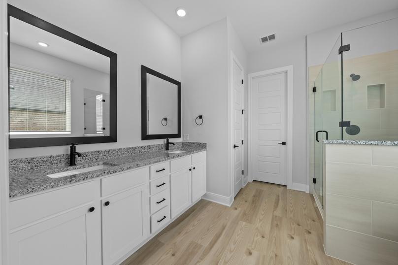 The master bath showcases a large vanity and a walk-in shower.