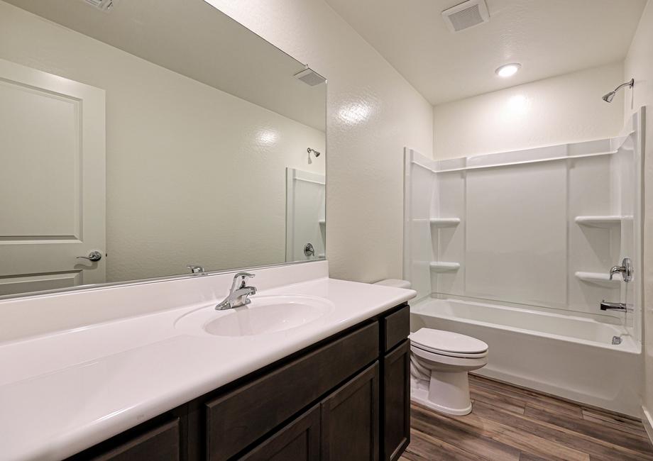 The secondary bathroom has a beautiful vanity!