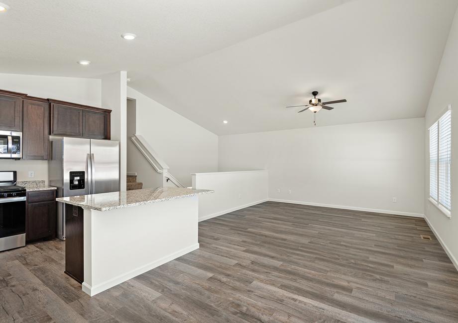 The open concept entertainment space includes the kitchen, dining, and family room