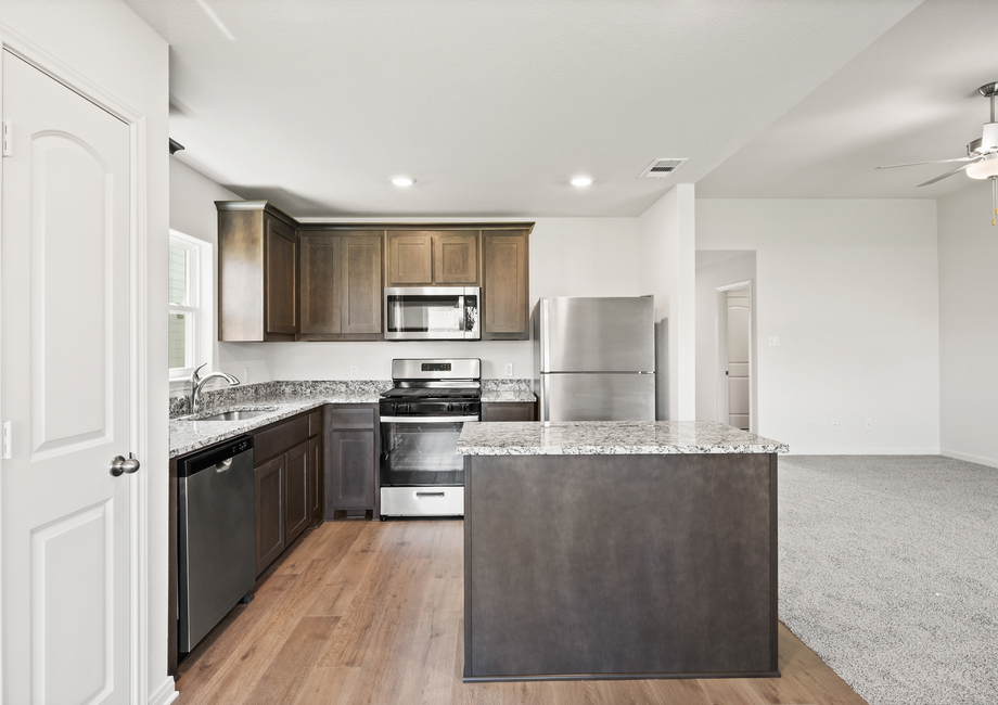 The beautiful kitchen has wood cabinetry.