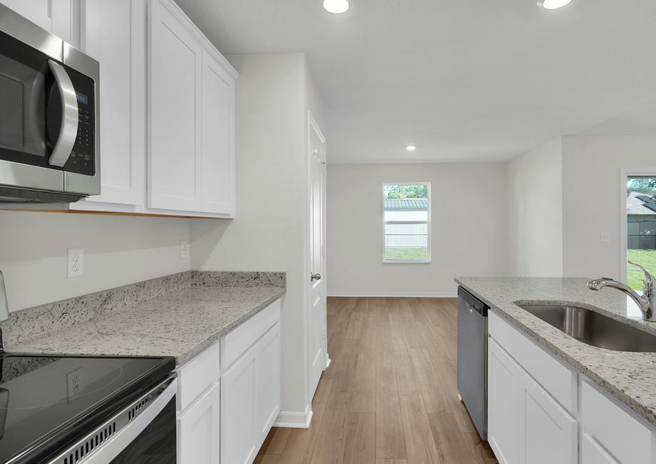 Enjoy stunning granite countertops and designer cabinetry in this kitchen.