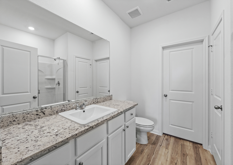 Dual sinks in the master bathroom and a step-in shower