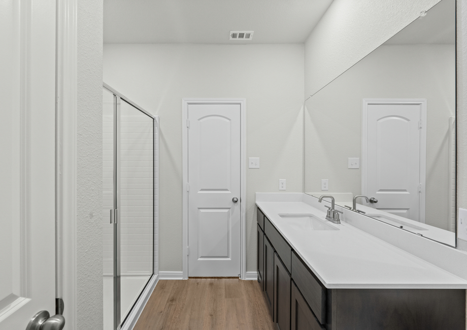 The master bathroom has a glass, walk-in shower.