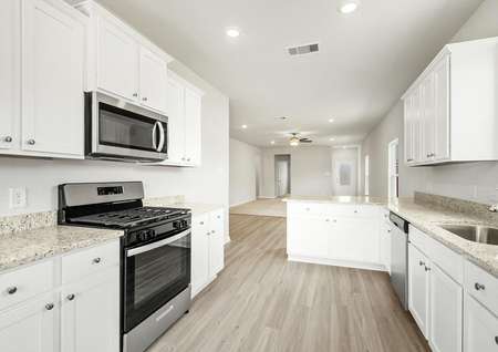 The chef ready kitchen has stainless steel appliances and white cabinets. 