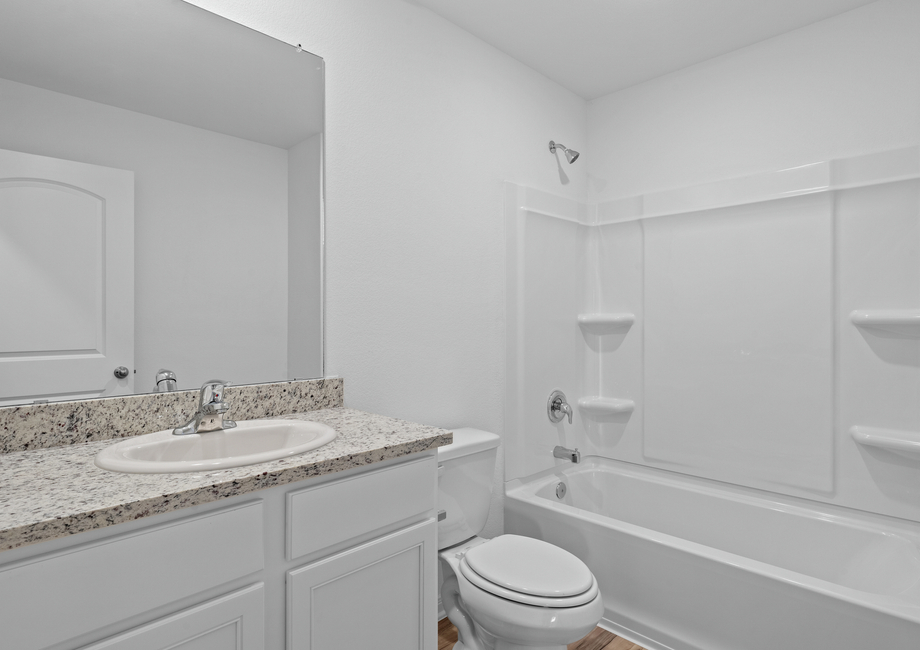 The secondary bathroom with granite countertops