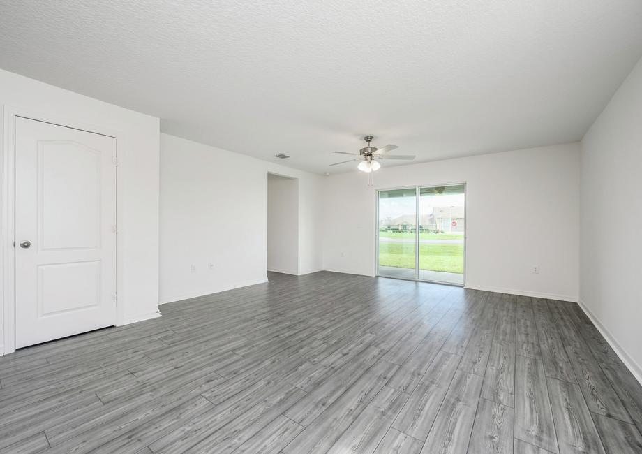 The family room is spacious and has a sliding glass door leading out onto the back patio