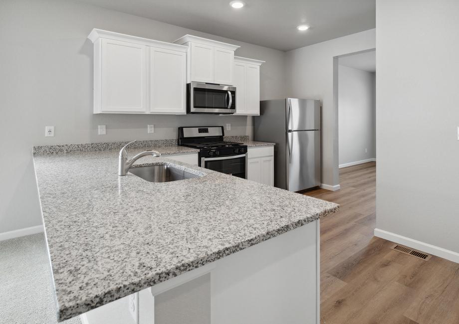 Upgraded kitchen with stunning cabinetry and sprawling countertops.
