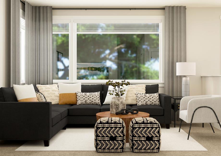 Rendering of flex space furnished with a
  dark grey sectional and a white chair.