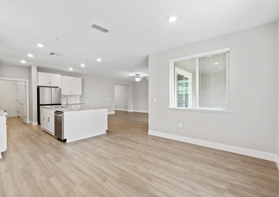 The kitchen, dining room, and living room let in beautiful natural lighting.